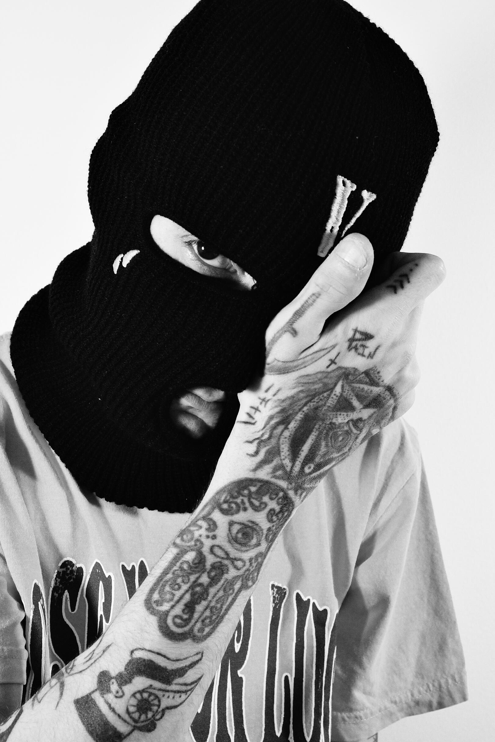 Jay Honest Home Portrait 3 featuring vlone facemask showing his tattoos.